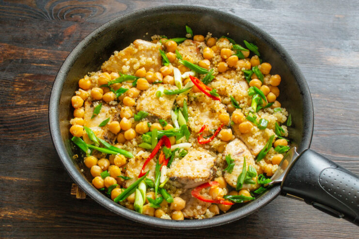 The final dish of chicken, quinoa, and chickpeas in a skillet, ready to be served.