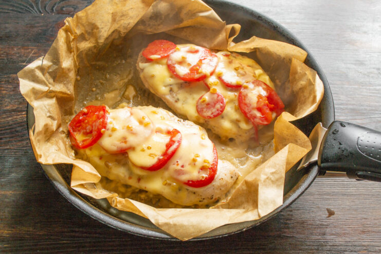 Melting the Cheese for a Perfect Finish Chicken breast with tomatoes and cheese cooking until the cheese is perfectly melted.