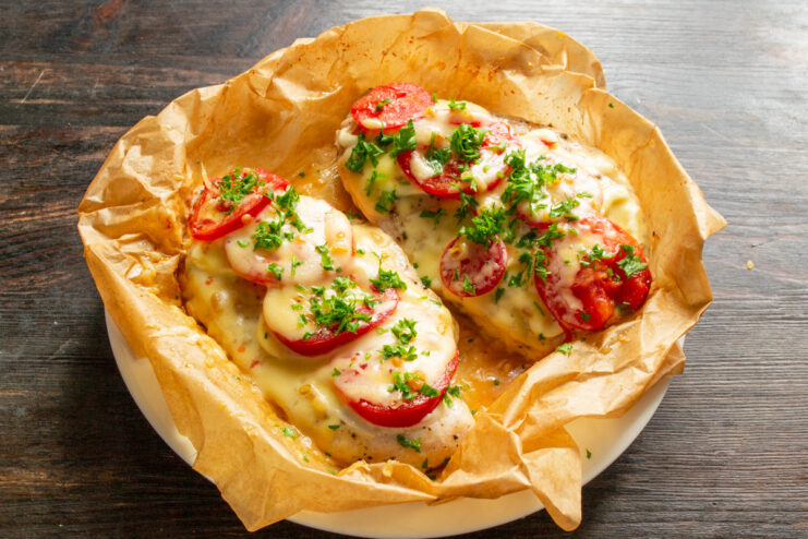 Enjoy Your Delicious Homemade Chicken Dish! A close-up shot of the perfectly cooked chicken breast with tomatoes and melted cheese.