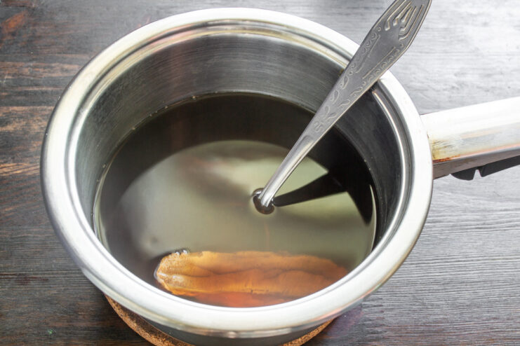 Boiling Rehydrated Mushrooms for the Sauce Rehydrated mushrooms boiling in a pot of water.