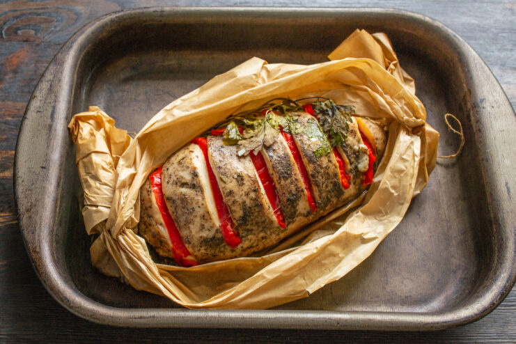 Unveiling the Perfectly Baked Chicken Fillet en Papillote The baked chicken fillet being unwrapped from the parchment paper, ready to be served.