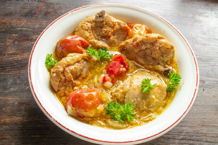 Serving Suggestion: Garnish and Pair with Your Favorite Side The final dish of honey-glazed chicken thighs served on a plate with mashed potatoes and garnished with parsley.