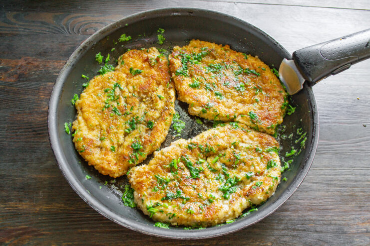 Serving the Hot and Delicious Chicken Schnitzels A finished plate of chicken schnitzels with cilantro butter, ready to be served.