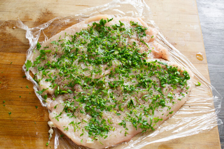 Adding Fresh Herbs for Extra Flavor in Your Chicken Roulade Finely chopped fresh parsley sprinkled over a seasoned, pounded chicken breast.