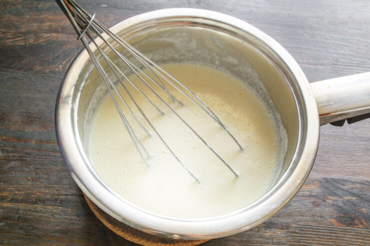 Making a roux for the creamy béchamel sauce Making a roux by cooking flour in melted butter in a saucepan for the béchamel sauce.
