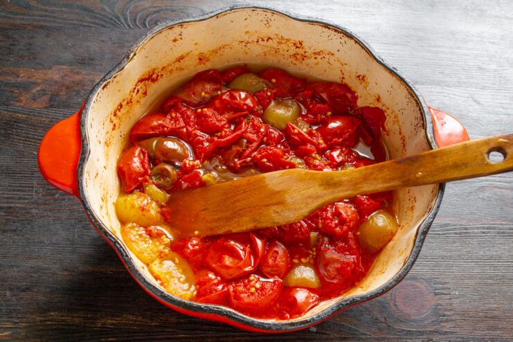Simmering Tomatoes and Physalis to Create a Rich Sauce A pot of simmering tomatoes and physalis cooking down into a sauce.