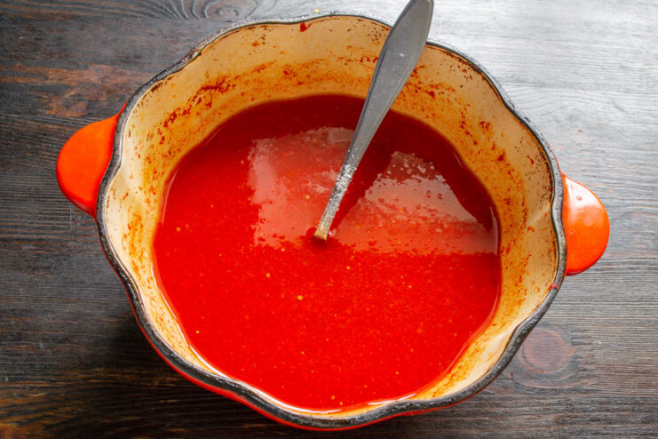 The Smooth Tomato and Physalis Base for Lecho A pot filled with the smooth, sieved tomato and physalis sauce.