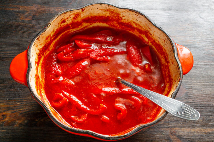 Simmering the Lecho to Perfection The lecho simmering in a large pot, with strips of red pepper visible in the sauce.
