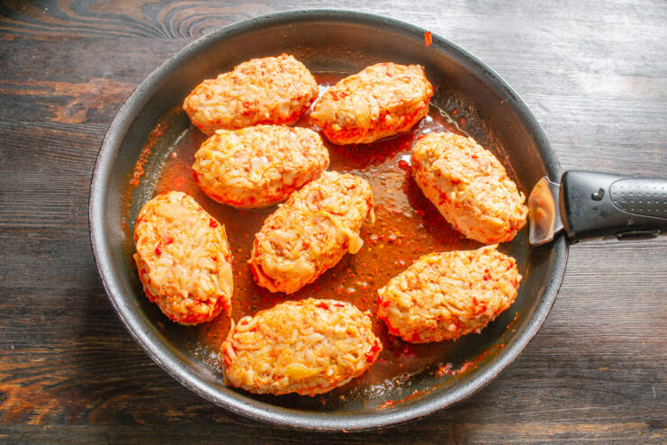 Baking the Lazy Cabbage Rolls in the Oven A skillet with lazy cabbage rolls in tomato sauce being placed into an oven.