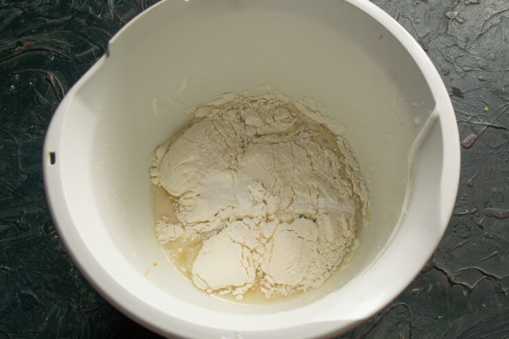 Combining Wet Ingredients for the Batter A bowl containing sugar, lemon juice, egg yolks, and vegetable oil before mixing.