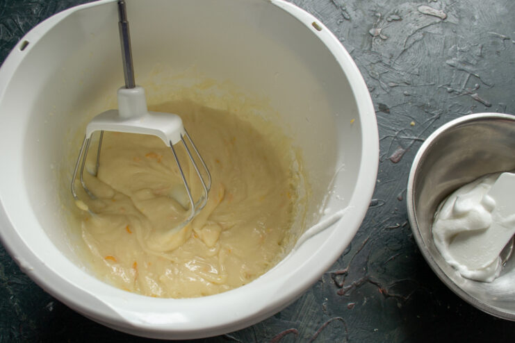 Mixing the Dough Until Smooth A stand mixer with a dough hook attachment mixing the lemon bun batter in a bowl.