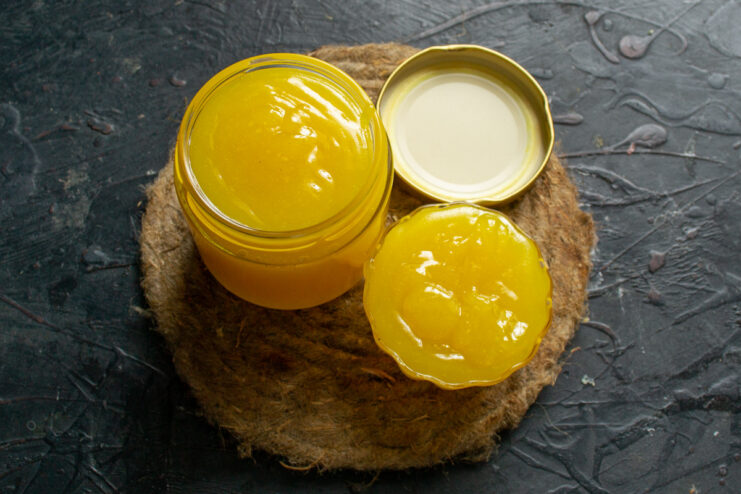 Chilling the Lemon Curd to Achieve the Perfect Thick Consistency A jar of chilled lemon curd, showing its thick, spreadable texture.