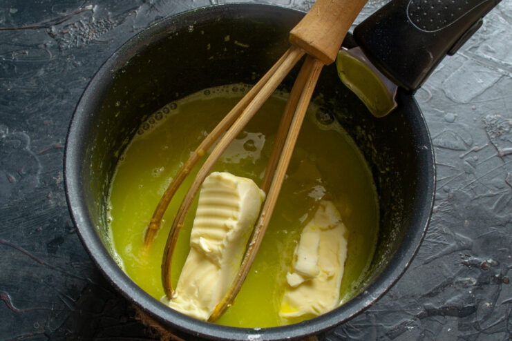 Adding Butter for a Rich, Silky Smooth Lemon Curd Adding cubes of butter to the warm, strained lemon curd.