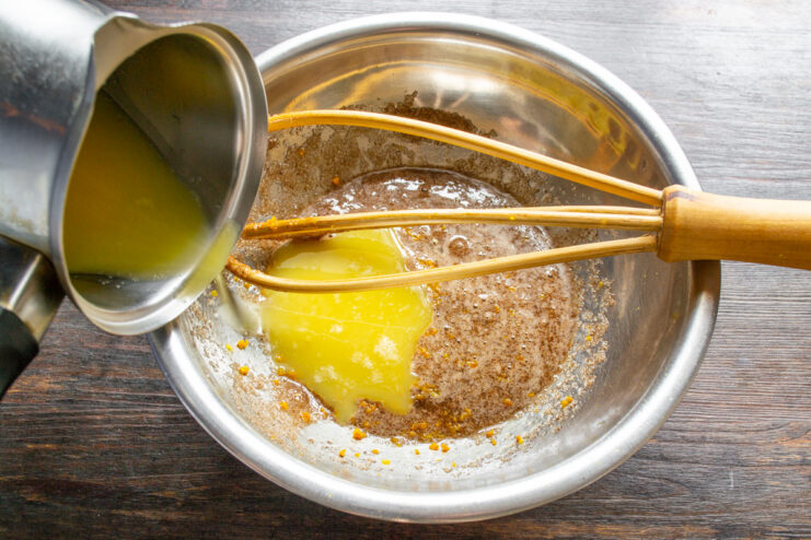 Step 3: Melting butter in a saucepan for the muffin batter A saucepan on a stove with butter melting inside.