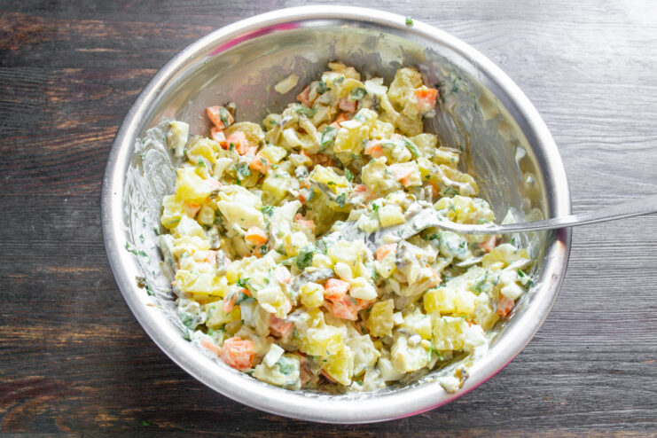 Letting the Potato Salad Flavors Meld The finished potato salad in a glass bowl, mixed and ready to rest.
