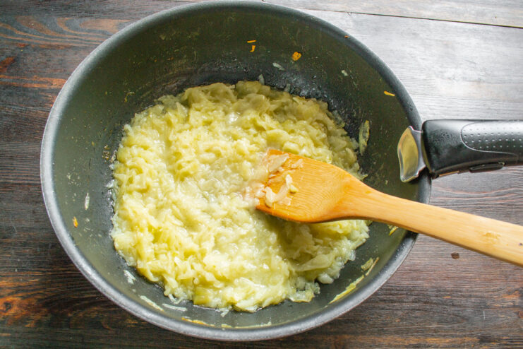 Slowly Caramelizing Onions for a Deep, Rich Flavor Onions being slowly caramelized in a skillet, turning a light golden brown.