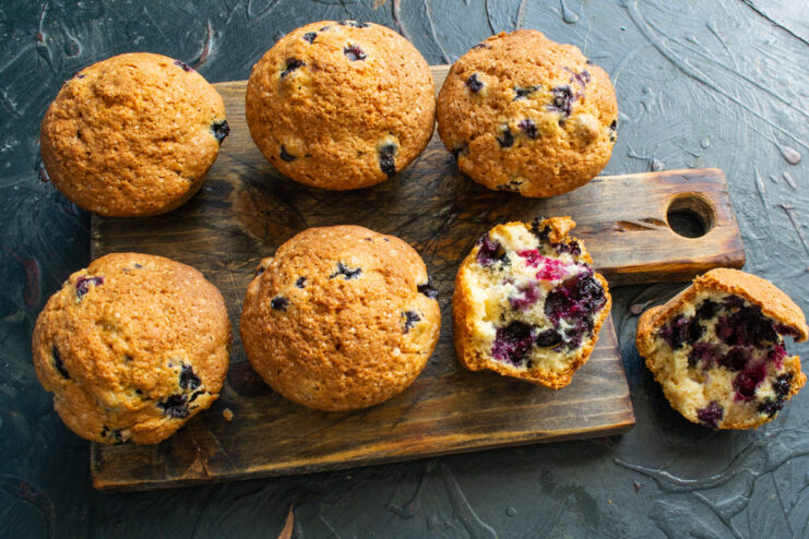 Let the muffins cool slightly in the tin before removing them Freshly baked blueberry muffins cooling in a metal muffin tin.