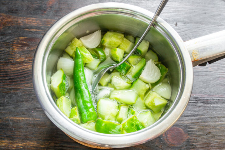 Cooking the Pickle Mixture on the Stove A covered pot with vegetables for pickling sitting on a stovetop.