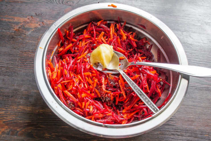 A touch of honey balances the acidity and spice, adding a lovely sweetness. Adding a spoonful of honey to the Moroccan beet and carrot salad before mixing.