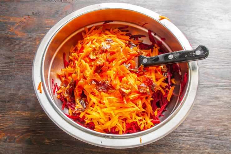 Properly cleaning dried fruits is an important step for both hygiene and texture. Dates and dried apricots in a bowl being rinsed with hot water.