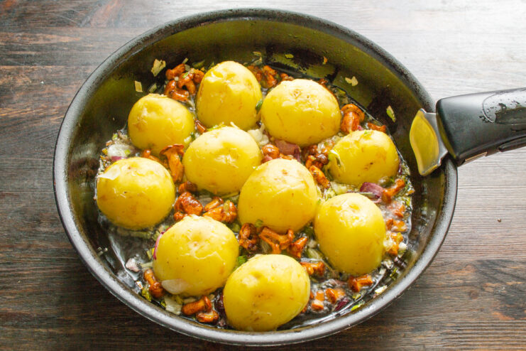 Placing potatoes cut-side down in the pan for a perfect golden crust. Halved new potatoes arranged cut-side down in a hot skillet.