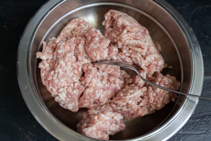 A bowl of fresh ground meat, the base for the Egyptian kebab recipe. A close-up of a bowl of raw ground meat ready for making kebabs.