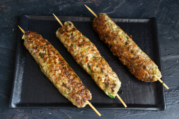 Perfectly cooked Egyptian meat kebabs ready to be served. A plate with freshly cooked, golden-brown meat kebabs.