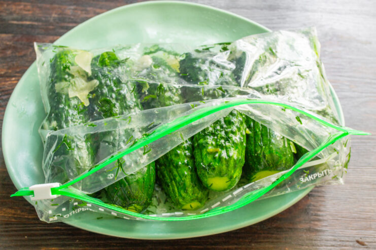 You can control the flavor from fresh and lightly salted to tangy and fermented. A sealed bag of cucumbers pickling on a kitchen counter.