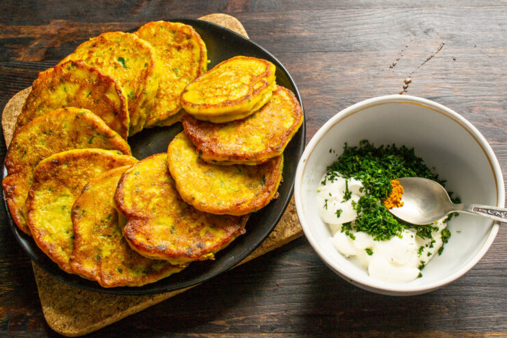 Preparing the Creamy Turmeric and Dill Sauce. A perfect complement to the savory pancakes. A bowl of creamy yellow sauce being mixed, with fresh dill and turmeric visible.