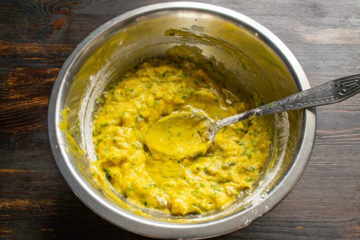 Adding Oil for Moisture and Tenderness. A neutral oil works best for this recipe. Vegetable oil being poured from a bottle into the pancake batter in a bowl.