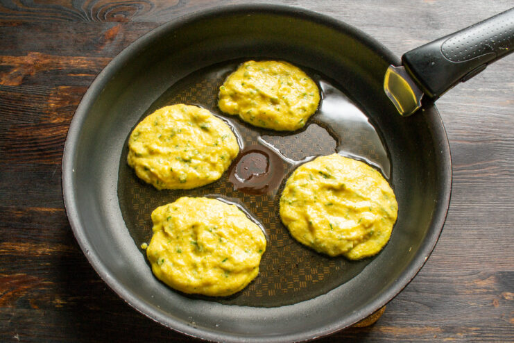 Frying the Pumpkin Pancakes. Use a tablespoon to create evenly sized pancakes. A tablespoon dropping portions of pumpkin pancake batter into a hot, oiled skillet.