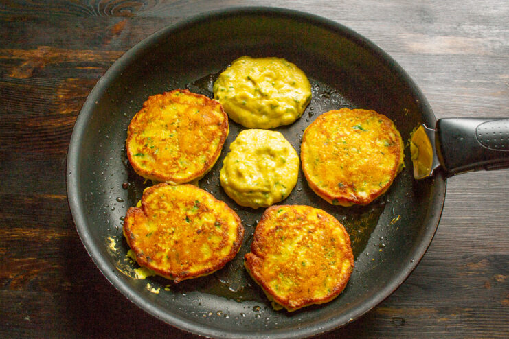 Achieving the Perfect Golden-Brown Crust. Fry for 3-4 minutes per side for best results. Several pumpkin pancakes frying in a skillet, showing a golden-brown color.