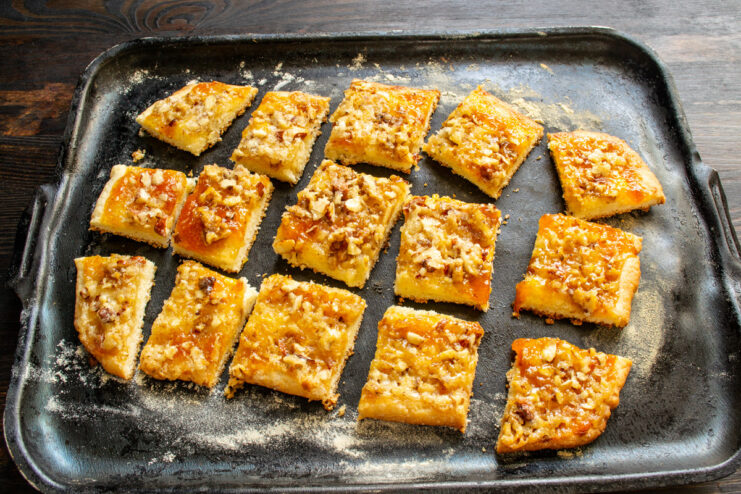 Serving the finished nut and apricot jam cookies Finished nut and apricot jam cookies, cut into squares and served on a plate.
