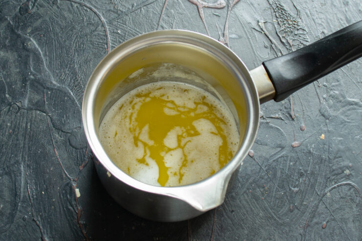 Preparing the wet ingredients: melted butter A small saucepan with melted butter inside.