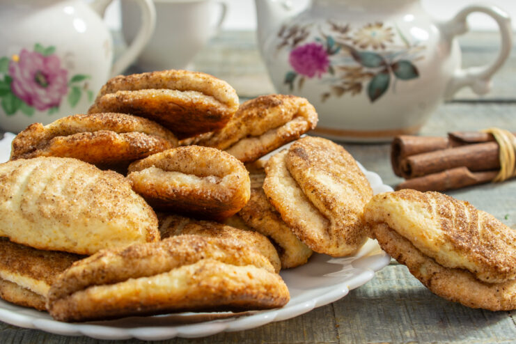 A plate of freshly baked Tvorog and Cinnamon Cookies, golden brown and sprinkled with sugar.