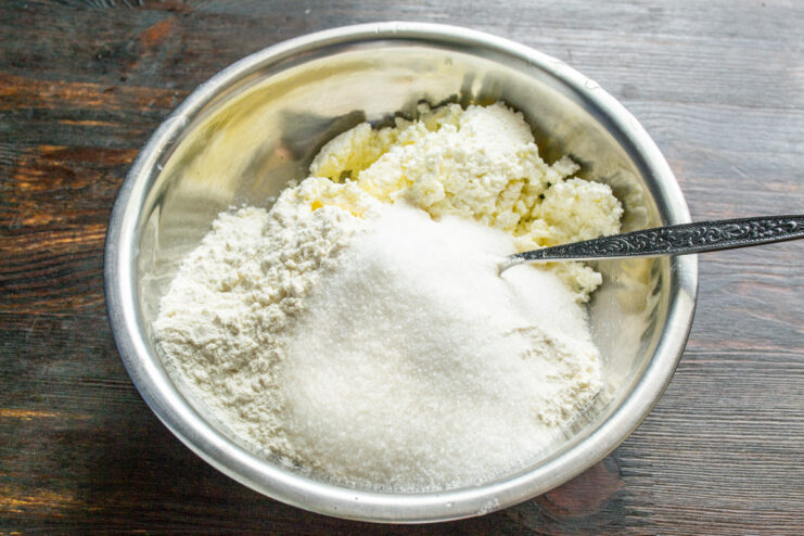 Adding sugar to the cookie dough mixture for sweetness. Adding a portion of granulated sugar to the cookie dough ingredients in a bowl.