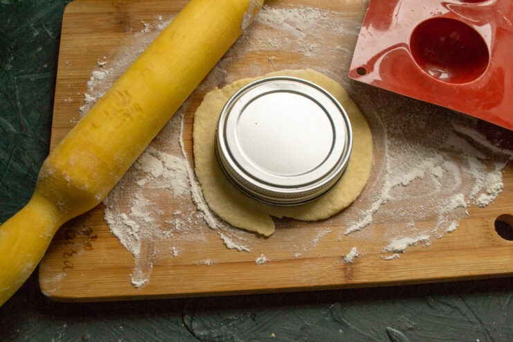 Cutting Circles for the Cookie Base Using the rim of a glass to cut circles from the rolled-out dough.