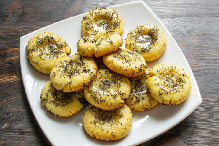 Let the cookies cool completely before serving for the best texture. Freshly baked honey and poppy seed cookies cooling on a wire rack.