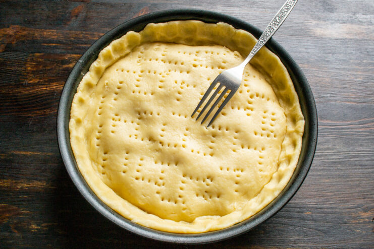 Venting the Pie Crust to Release Steam Pricking the top of the pastry with a fork before baking.