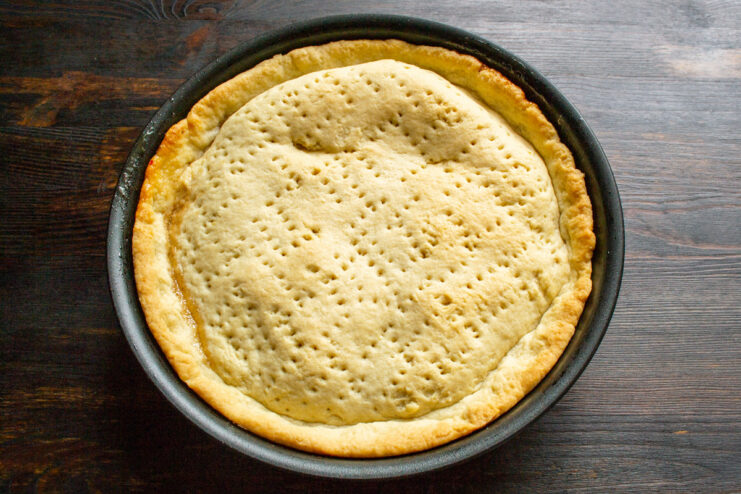 Baking the Upside-Down Apple Pie to Golden Perfection Placing the skillet with the apple pie into a hot oven.