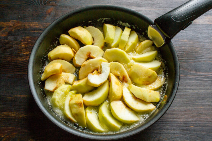 Preparing the Apples for the Pie Filling Freshly sliced apples arranged on a wooden cutting board.