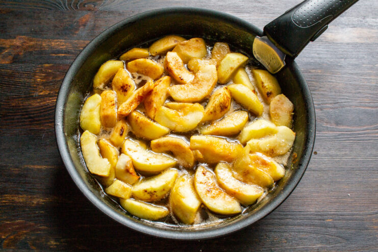 Cooling the Spiced Apple Filling Before Adding the Pastry Caramelized apple filling in a skillet, sprinkled with cinnamon.