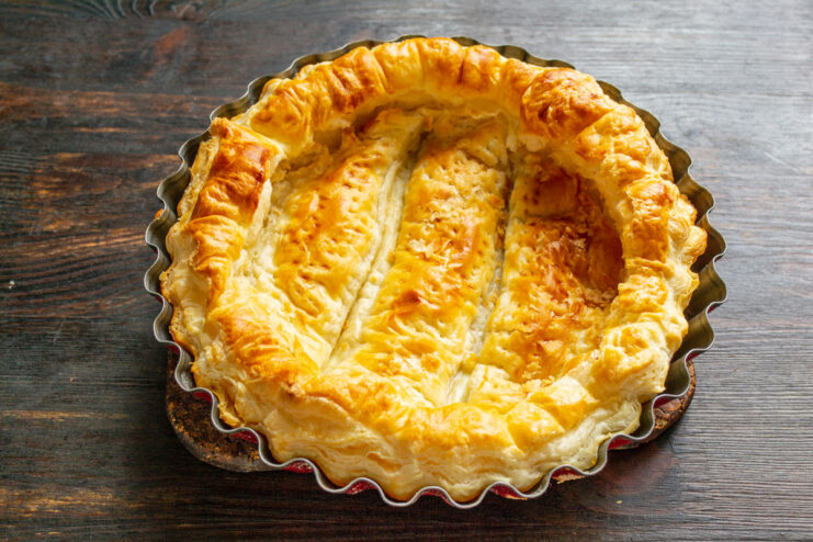 Baking the Puff Pastry Crust Until Golden - The perfectly baked base for our strawberry pie. A golden-brown, baked puff pastry crust fresh out of the oven in its baking pan.