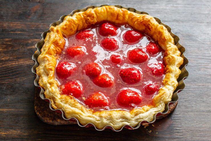Chilling the Pie to Set the Filling - The final step before slicing and enjoying. The finished puff pastry strawberry pie, with a glossy red topping, ready to be chilled.