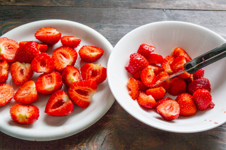 Preparing Fresh Strawberries for the Pie Filling - Halving some for decoration and dicing the rest. A bowl of freshly chopped strawberries, with some larger berries cut in half for decoration.