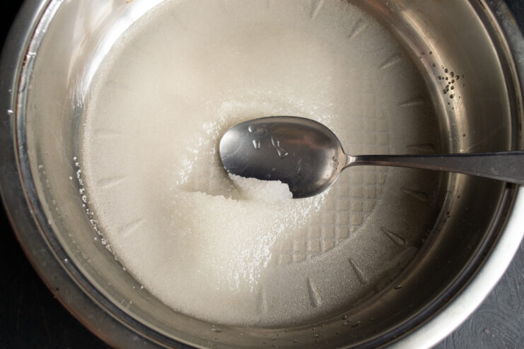 Sugar and water in a saucepan, about to be heated to make a simple syrup.