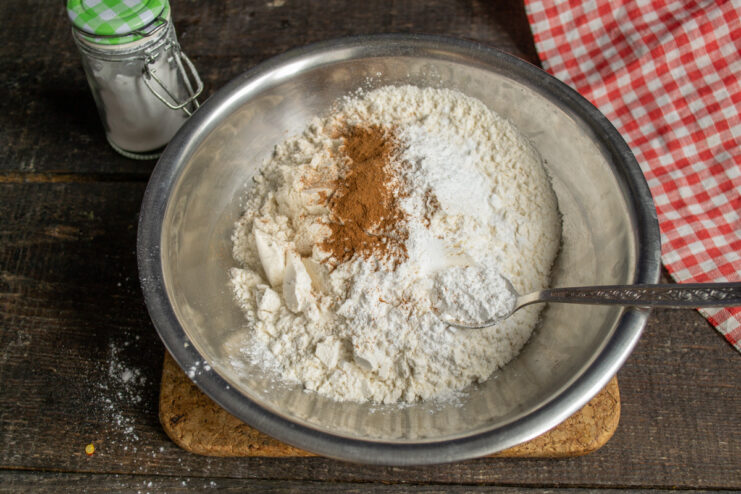 Step 5: Mixing the Dry Ingredients A bowl containing flour, baking powder, and cinnamon, representing the dry ingredients for the cake.