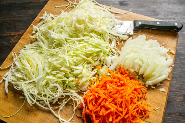 Preparing the Cabbage for the Pie Filling Thinly shredded white cabbage in a pile, ready for cooking.