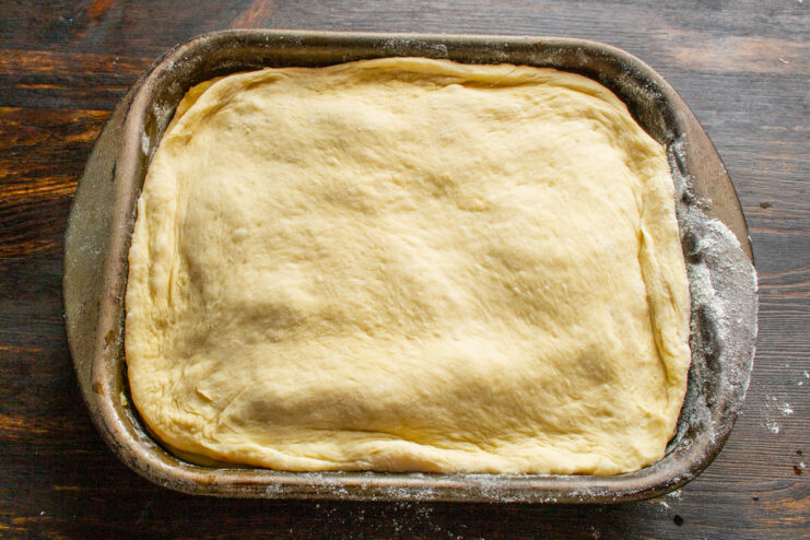 Sealing the Cabbage Pie Before Baking The top layer of dough placed over the filling, with the edges being crimped.