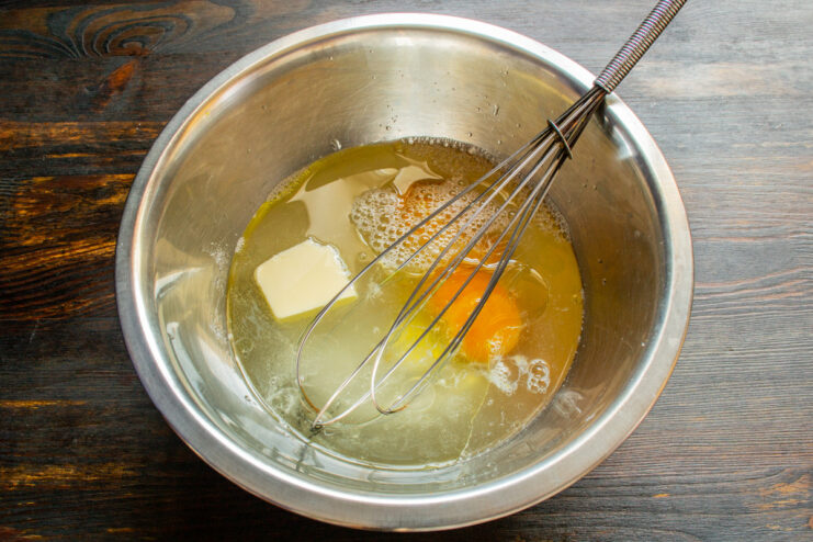 Simmering the Cabbage Pie Filling Until Tender Cabbage, carrot, and apple filling simmering in a deep pan.